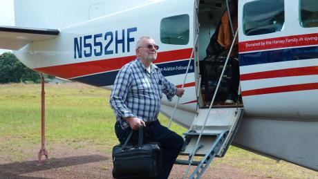 Jonathan Greenham boarding MAF aircraft from Harper.