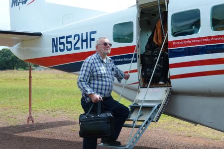 Jonathan Greenham boarding MAF aircraft from Harper.