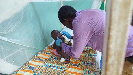 Charles Jarsor Director of Nursing and Midwifery caring for George Alison